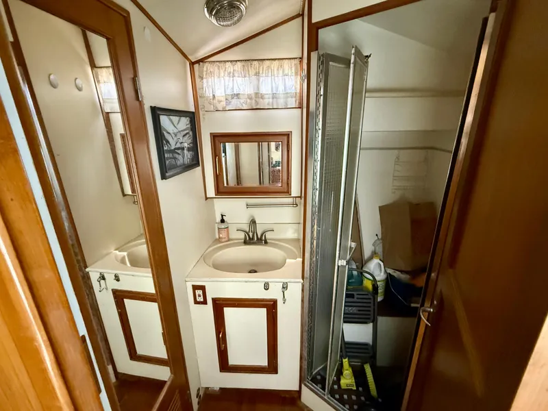 Slide: The Image of 1986 Kha Shing Nautique bathroom with sink, mirror, and shower. - 22