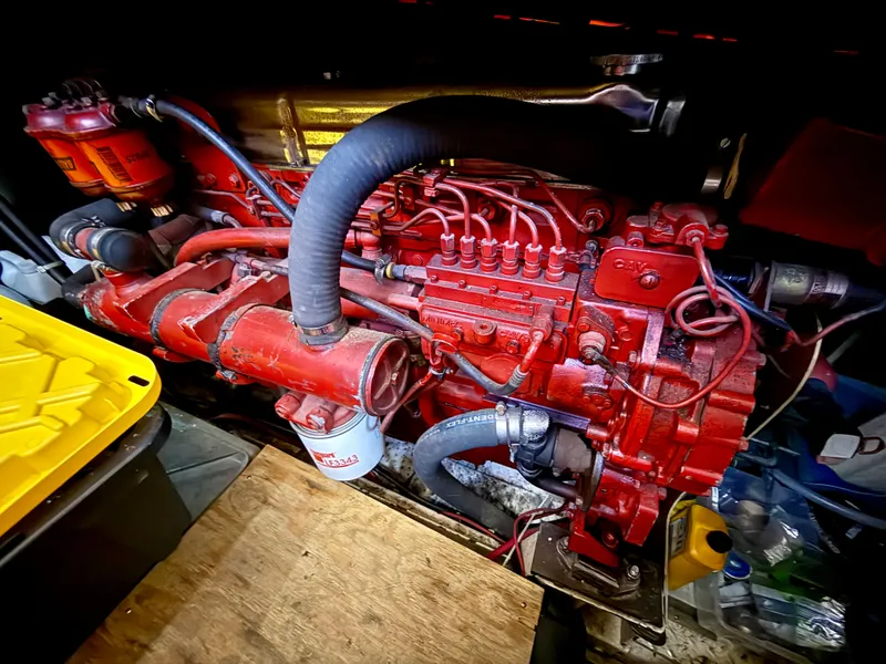Slide: The Image of 1986 Kha Shing Nautique engine, vibrant red, detailed components, in a workshop setting. - 28