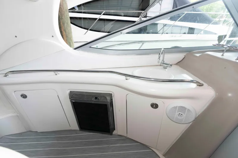Slide: The Image of 2005 Sea Ray 300 Sundancer interior with sink and storage compartments. - 16