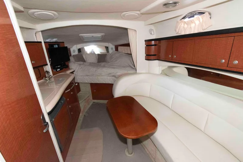 Slide: The Image of Interior of 2005 Sea Ray 300 Sundancer with cozy seating and sleeping area. - 19