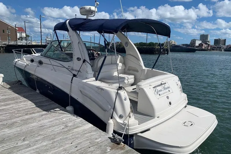 Slide: The Image of 2005 Sea Ray 300 Sundancer docked at marina under blue sky. - 2