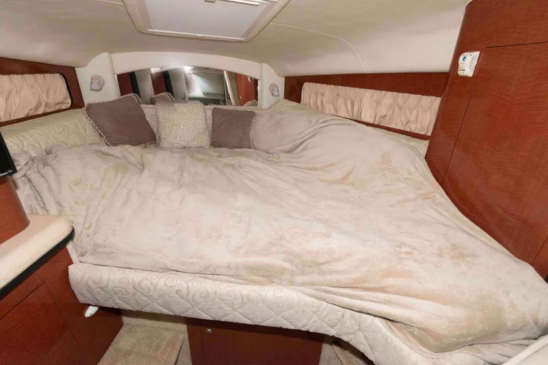Slide: The Image of Cozy cabin interior of 2005 Sea Ray 300 Sundancer with plush bedding and pillows. - 22