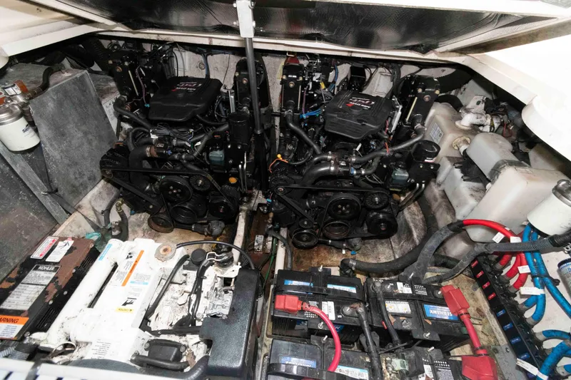 Slide: The Image of Engine compartment of a 2005 Sea Ray 300 Sundancer with dual engines and batteries. - 26