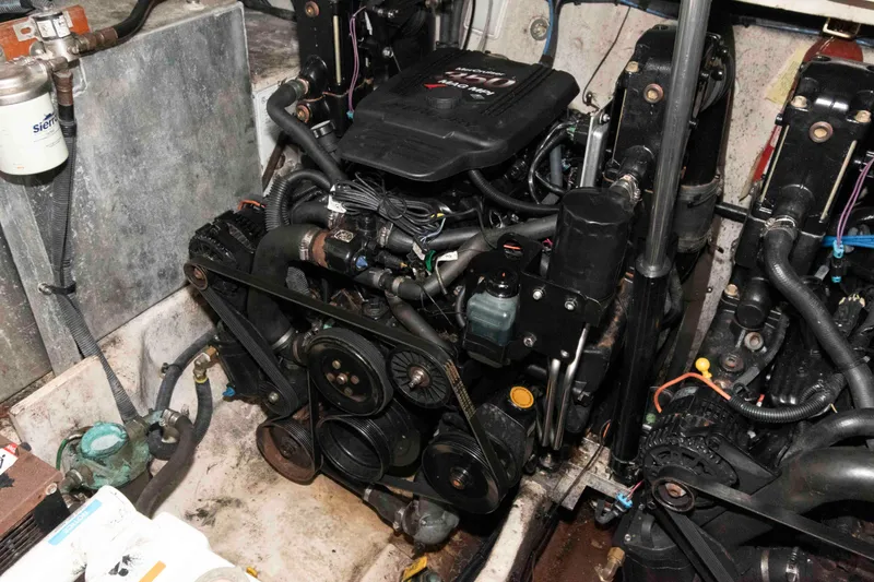 Slide: The Image of Engine compartment of a 2005 Sea Ray 300 Sundancer boat, showcasing mechanical components. - 27