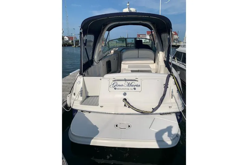 Slide: The Image of 2005 Sea Ray 300 Sundancer docked, rear view with canopy and seating area. - 3