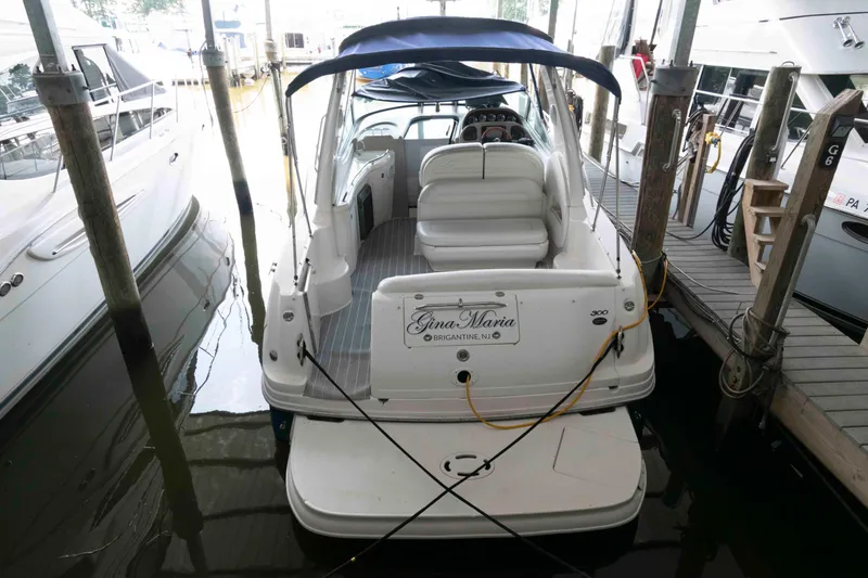 Slide: The Image of 2005 Sea Ray 300 Sundancer docked, rear view with seating and canopy. - 5