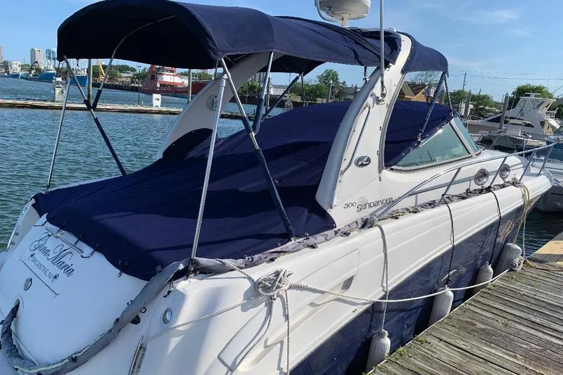 Slide: The Image of 2005 Sea Ray 300 Sundancer docked at marina with blue canopy. - 9