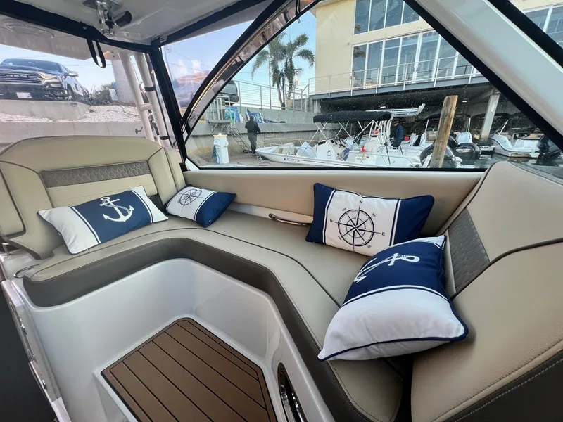 Slide: The Image of Luxurious interior of 2019 Pursuit 325 DC boat with nautical-themed cushions. - 10