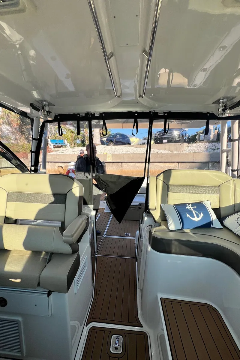 Slide: The Image of Interior of a 2019 Pursuit 325 DC boat with seating and nautical decor. - 11