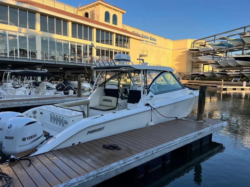 Slide: The Image of 2019 Pursuit 325 DC boat docked at marina with Yamaha engines. - 3