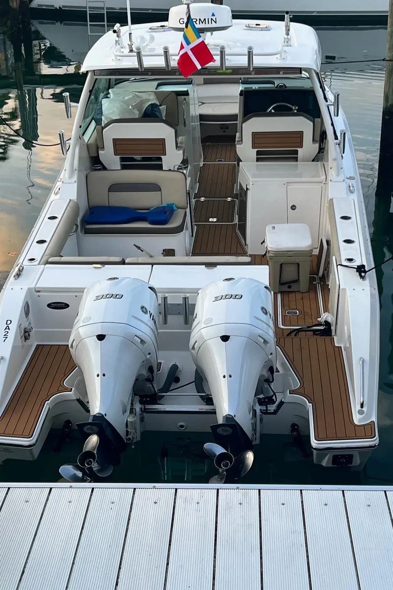 Slide: The Image of 2019 Pursuit 325 DC boat with dual engines docked at marina. - 5