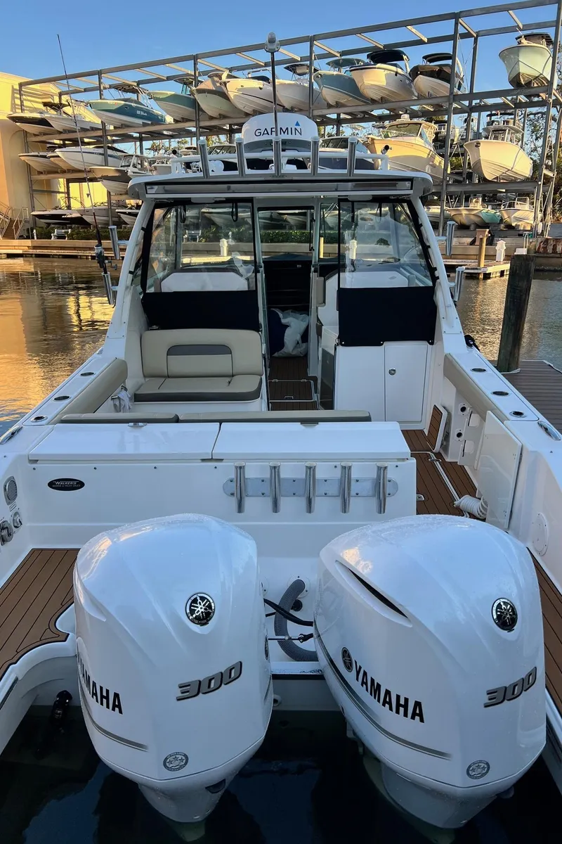 Slide: The Image of 2019 Pursuit 325 DC boat with twin Yamaha 300 engines docked at marina. - 7