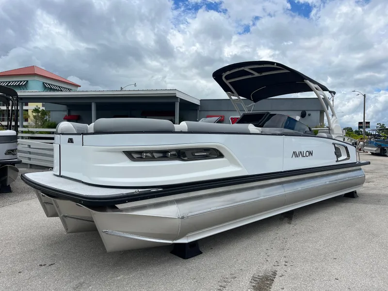 The Image of 2026 Avalon 2785 Excalibur LTD pontoon boat with Mercury 400hp V-10 engine, parked outdoors. - 1