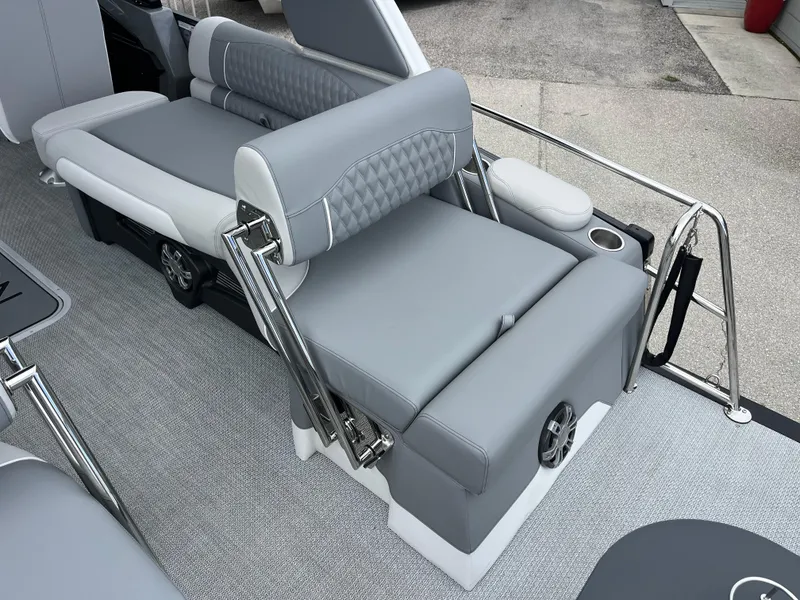 Slide: The Image of 2026 Avalon 2785 Excalibur LTD boat interior with gray quad lounger seating and cup holder. - 22