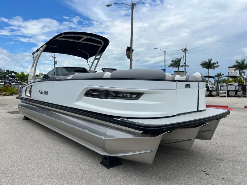 Slide: The Image of 2026 Avalon 2785 Excalibur LTD Tri-toon boat with Mercury 400hp V-10 engine, docked outdoors. - 3