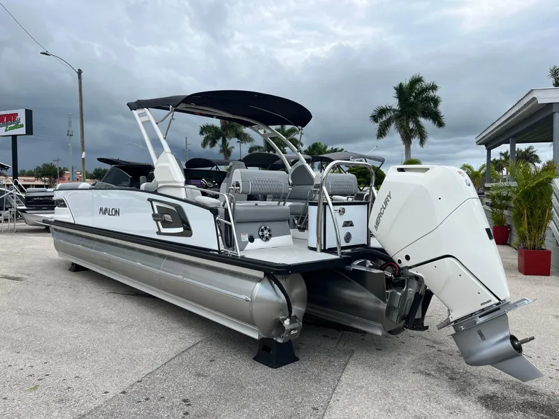 Slide: The Image of 2026 Avalon 2785 Excalibur LTD pontoon boat with Mercury 400hp V-10 engine, docked outdoors. - 7