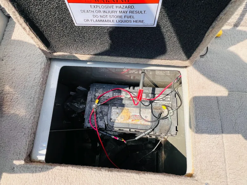 Slide: The Image of Battery compartment of 2004 Tracker Targa WT with warning label and wiring. - 10