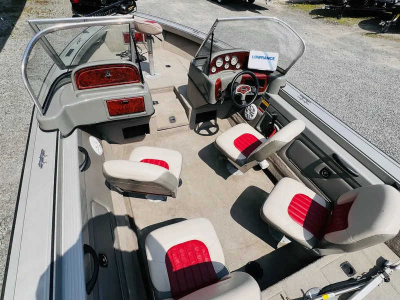 Slide: The Image of 2004 Tracker Targa WT boat interior with red and white seating, steering console, and Lowrance equipment. - 11