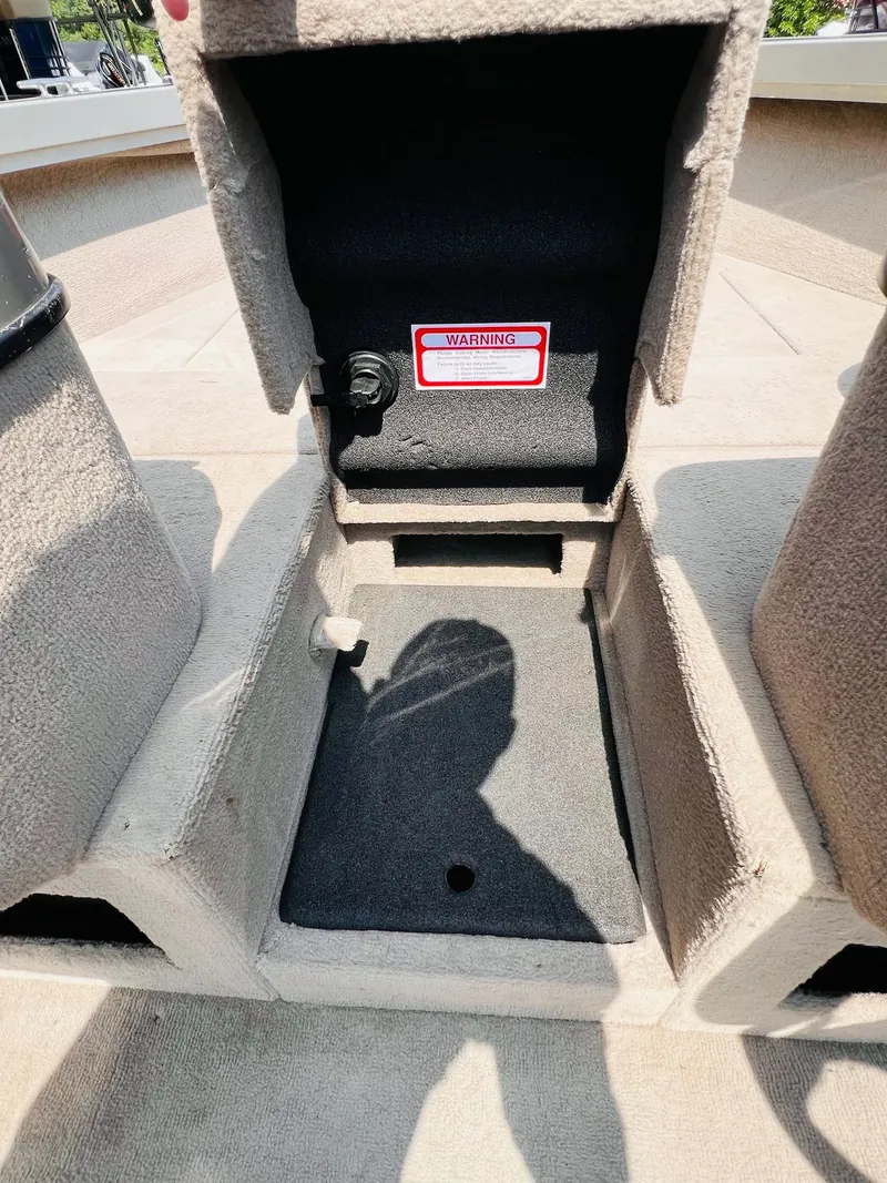 Slide: The Image of 2004 Tracker Targa WT boat interior storage compartment with warning label. - 12
