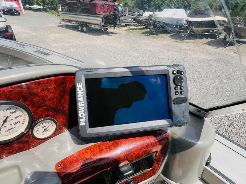 Slide: The Image of 2004 Tracker Targa WT dashboard with Lowrance fishfinder and speedometer. - 16