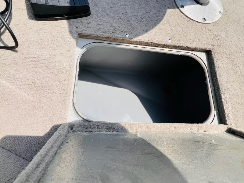 Slide: The Image of 2004 Tracker Targa WT boat storage compartment with open lid, showing interior space. - 17