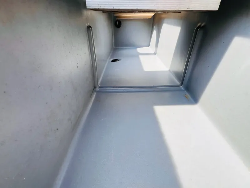 Slide: The Image of Interior view of a 2004 Tracker Targa WT boat compartment, showing clean, spacious storage. - 18