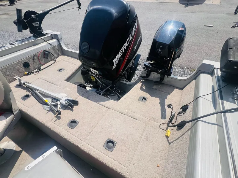 Slide: The Image of 2004 Tracker Targa WT boat interior with Mercury outboard motor and fishing equipment. - 20