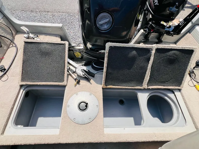 Slide: The Image of 2004 Tracker Targa WT boat interior with storage compartments and motor. - 22