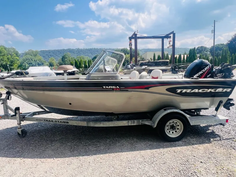 Slide: The Image of 2004 Tracker Targa WT boat on trailer, outdoors with scenic background. - 24