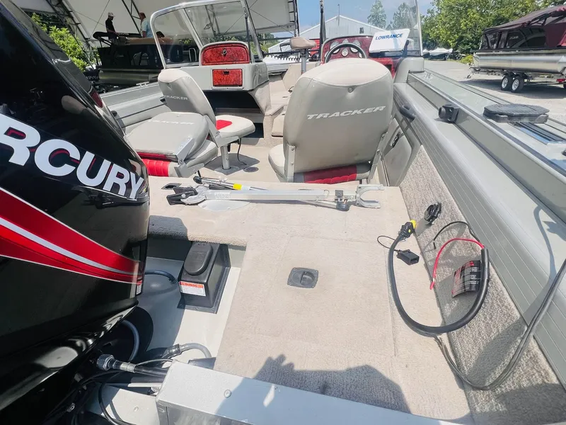 Slide: The Image of 2004 Tracker Targa WT boat interior with Mercury engine and fishing equipment. - 25