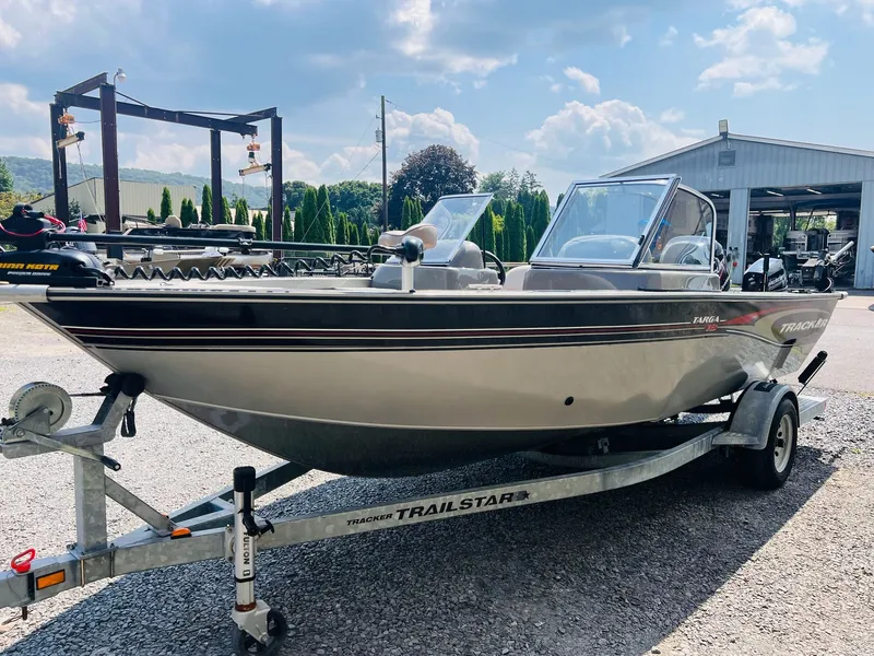 Slide: The Image of 2004 Tracker Targa WT boat on trailer, parked outdoors under a sunny sky. - 26