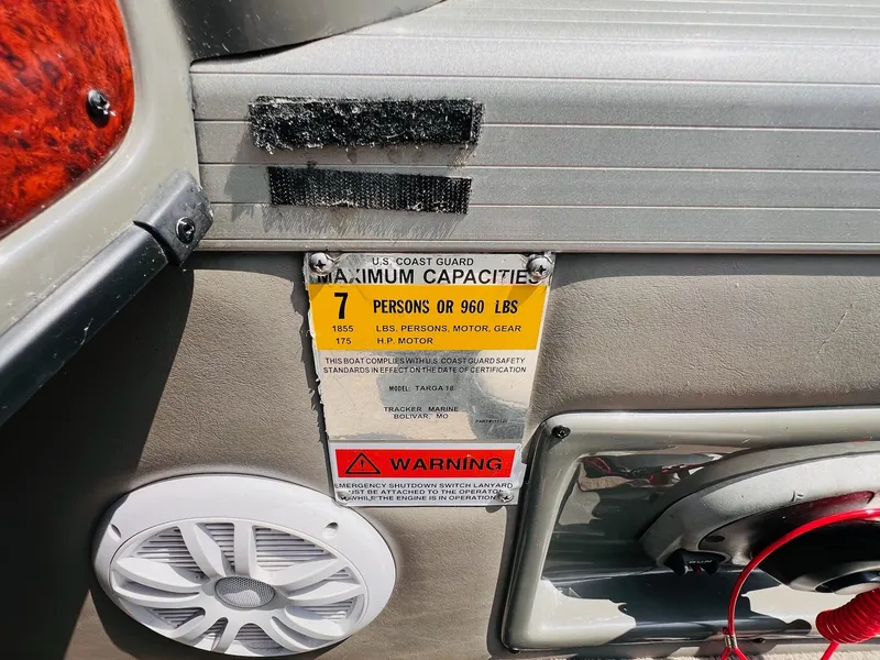 Slide: The Image of 2004 Tracker Targa WT capacity label, 7 persons or 960 lbs, safety warning visible. - 27