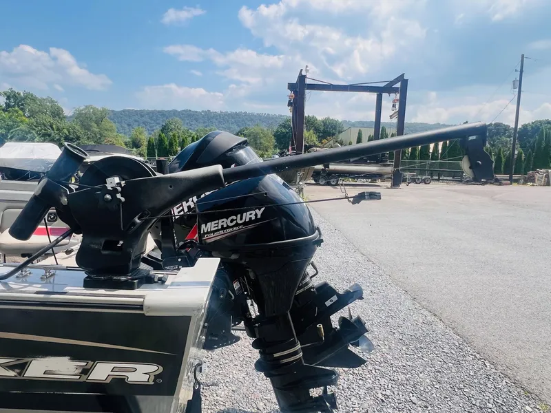 Slide: The Image of 2004 Tracker Targa WT boat with Mercury outboard motor in a sunny outdoor setting. - 28