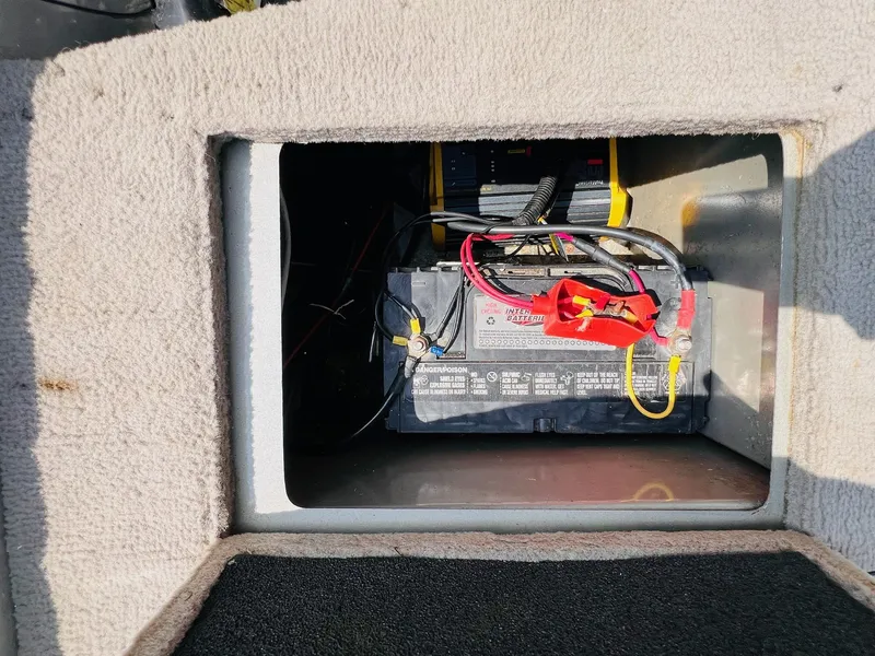 Slide: The Image of 2004 Tracker Targa WT battery compartment with visible wiring and connections. - 29