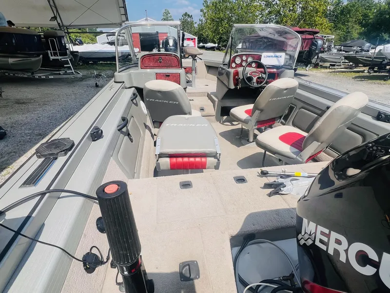 Slide: The Image of 2004 Tracker Targa WT boat interior with seating and control panel, displayed outdoors. - 30