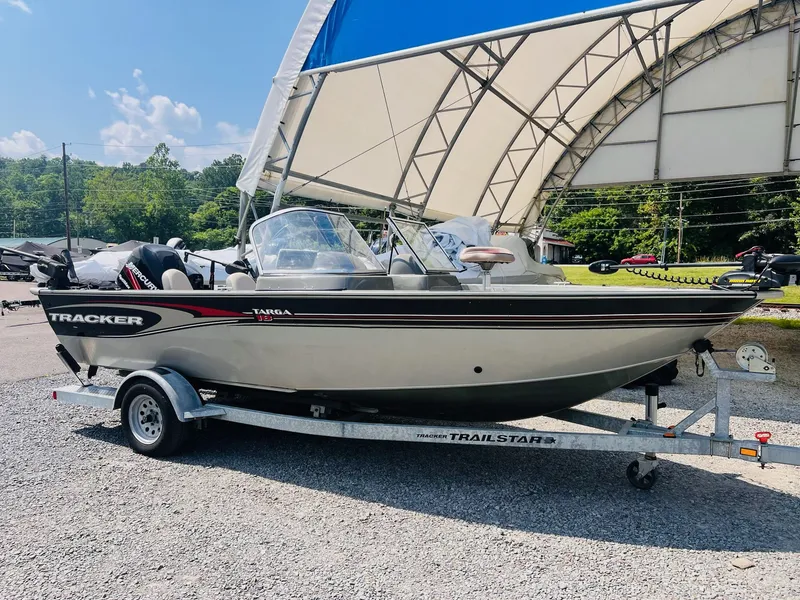 Slide: The Image of 2004 Tracker Targa WT boat on a trailer, parked outdoors under a canopy. - 32