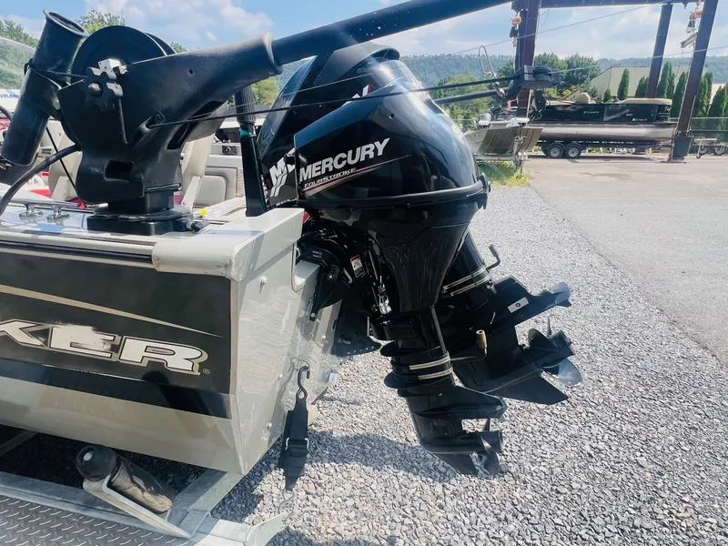 Slide: The Image of 2004 Tracker Targa WT boat with Mercury outboard motor on a gravel lot. - 37