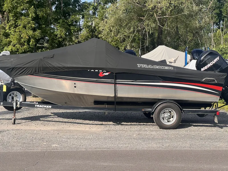 Slide: The Image of 2004 Tracker Targa WT boat with cover on trailer, parked outdoors. - 40