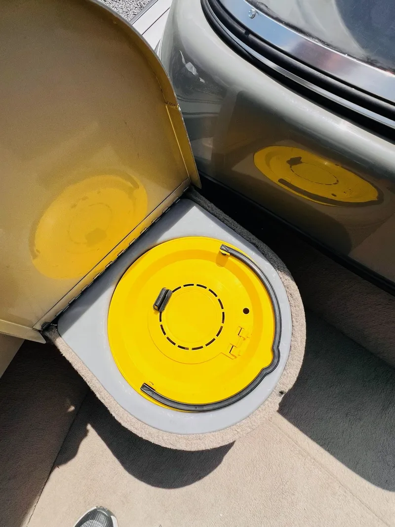 Slide: The Image of Yellow storage compartment in a 2004 Tracker Targa WT boat. - 6