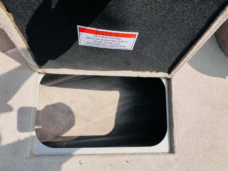 Slide: The Image of Open storage compartment in 2004 Tracker Targa WT boat with warning label. - 8