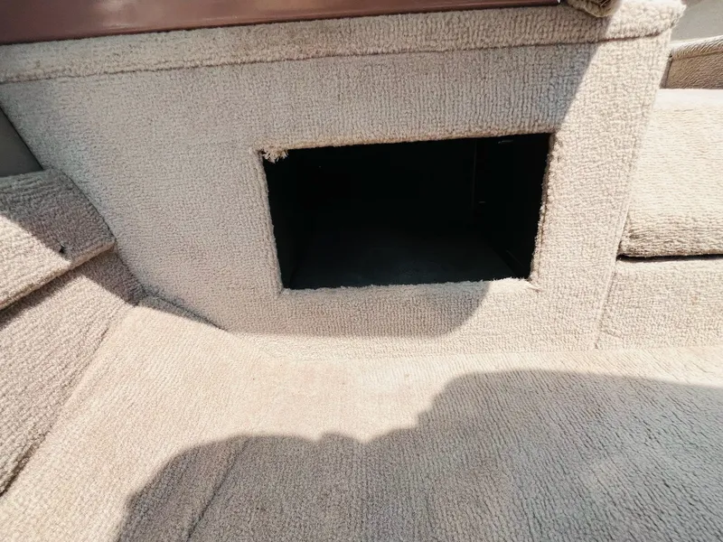 Slide: The Image of 2004 Tracker Targa WT boat interior with open carpeted storage compartment. - 9