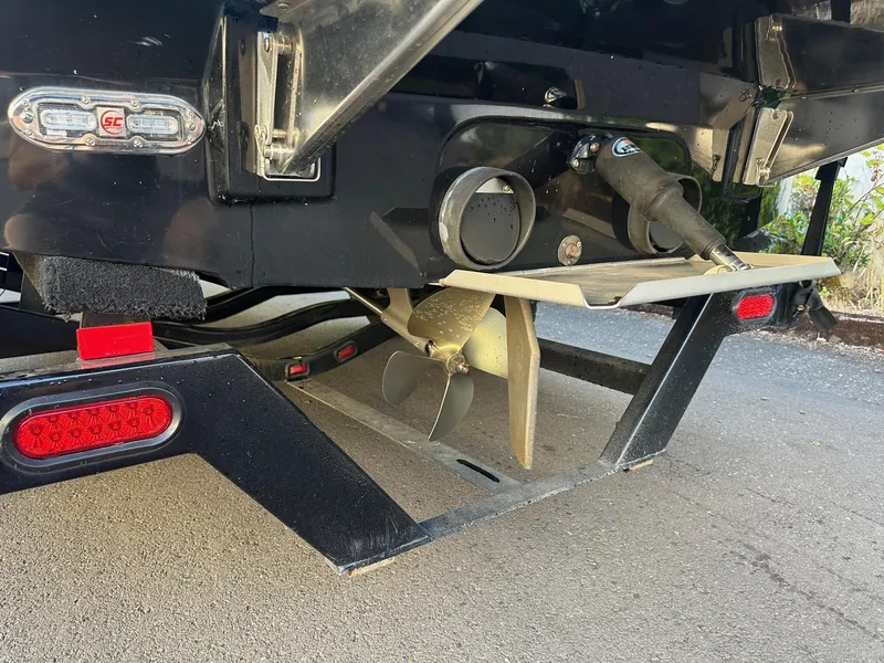 Slide: The Image of 2013 Supra SA350 boat propeller and trailer detail on pavement. - 10