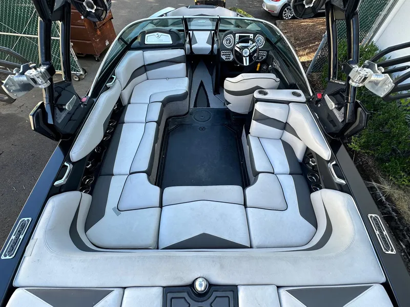 Slide: The Image of 2013 Supra SA350 boat interior with gray and white seating, steering wheel, and dashboard controls. - 11