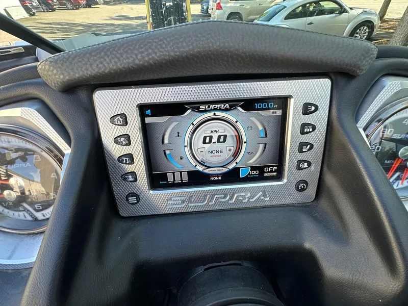 Slide: The Image of Dashboard of a 2013 Supra SA350 boat with digital display and controls. - 12