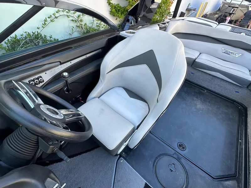 Slide: The Image of Interior of a 2013 Supra SA350 boat, featuring a sleek steering wheel and comfortable seating. - 14
