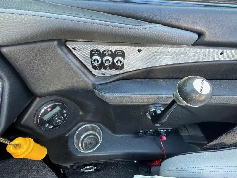 Slide: The Image of 2013 Supra SA350 dashboard with ballast controls and gear shift lever. - 15
