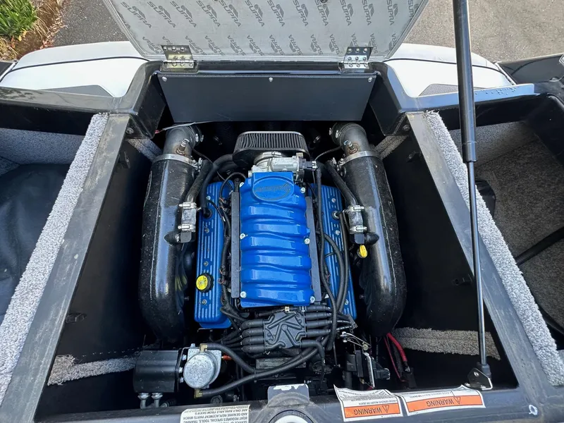 Slide: The Image of 2013 Supra SA350 engine compartment with blue engine cover and open hatch. - 17