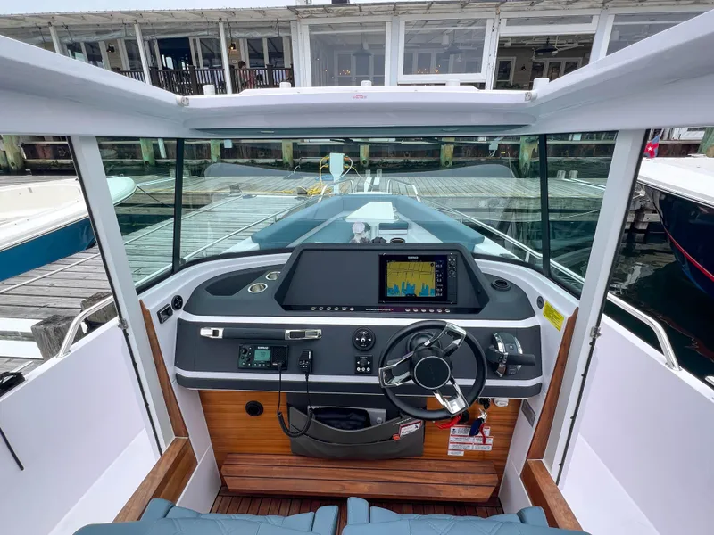 Slide: The Image of 2022 Axopar 28 Cabin Aft Cabin boat dashboard with modern navigation system. - 16