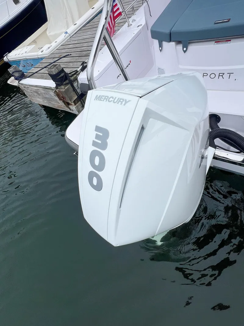 Slide: The Image of 2022 Axopar 28 Cabin with Mercury 300 outboard engine at dock. - 28