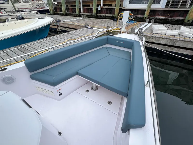 Slide: The Image of 2022 Axopar 28 Cabin Aft Cabin boat with blue seating at dock. - 8